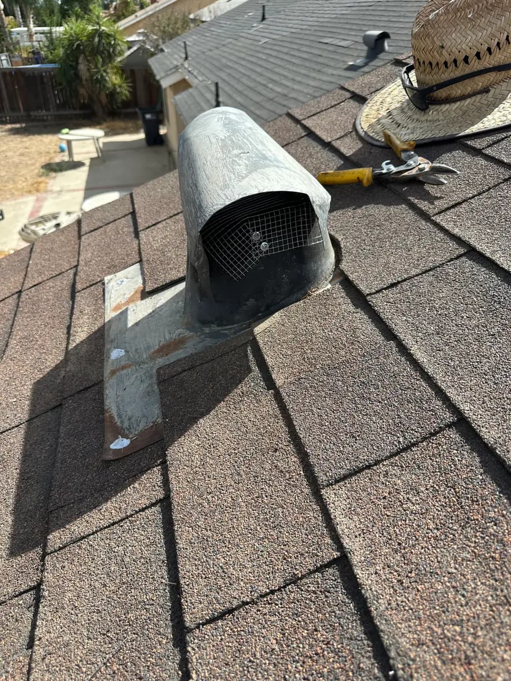 Close view of a roof vent on an asphalt shingle roof