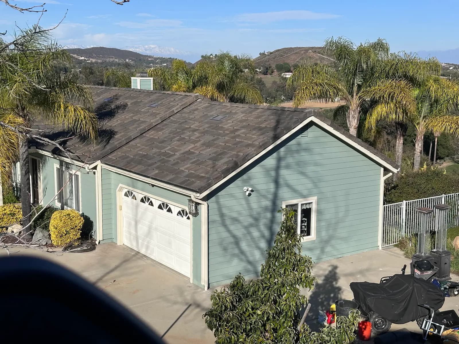 Wide view of a dark tile roof on a house